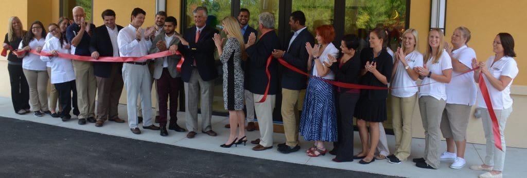 Key Influencers and staff cut the ribbon on one of the largest child development centers in Georgia, the Angel Learning Center. (LEFT TO RIGHT) Ashlee Reiser, Zoe Fernandez, Kelsey Zittrouer, Jennifer Hilton, John King, Matt Dowling, Adam Yanco, Danny Pinyan, Savan Patel, Mayor Eddie DeLoach, Laukik Patel, Sheri Showalter, Major Mike Lamb, Jay Patel, Cinda Young, Erica Rivera, Elizabeth Simons, Janisha Patel, Carly Hendrix, Chelsea Lukes, Stacy Hunte, Andrea Best Hensley