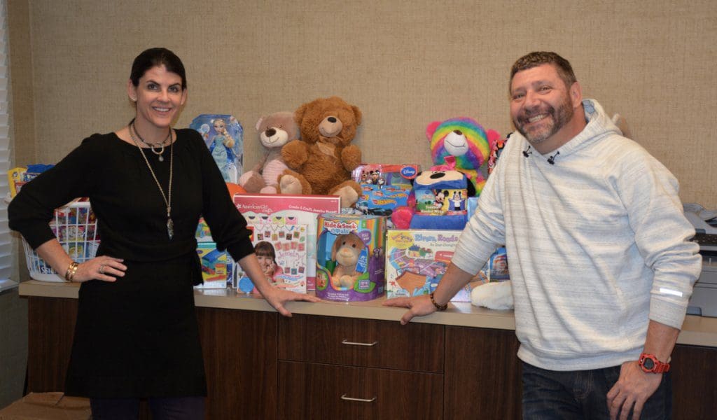 (LEFT TO RIGHT) Corinne Howington of Low Country Dermatology presents donations collected for the Ronald McDonald House to executive director Bill Sorochak