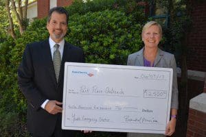 Pictured left to right: Chris Sotus, Resident Director for Merrill Lynch presented a $12,500 check from Bank of America to Julie Wade, Executive Director of Park Place Outreach Youth Emergency Shelter.