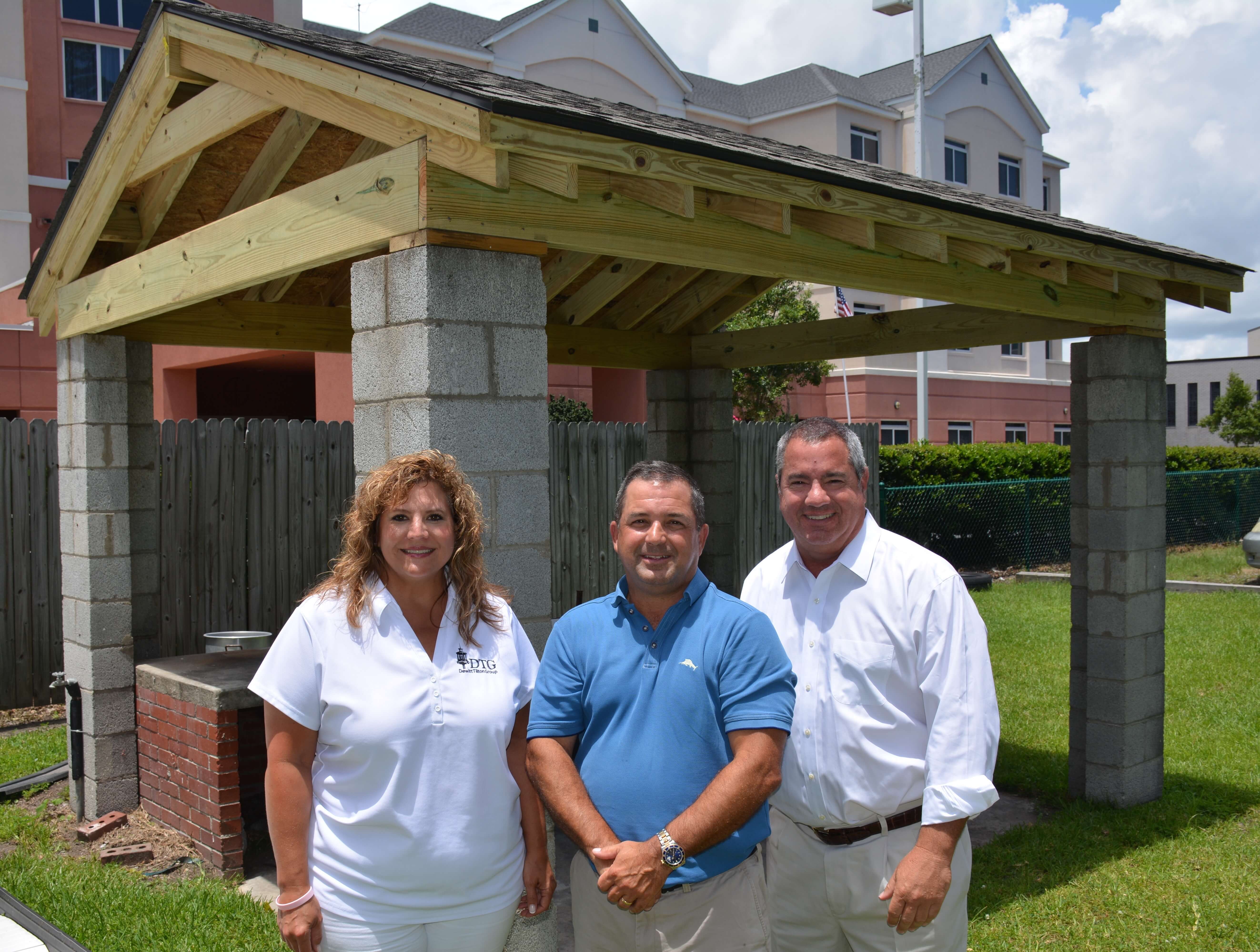 Pictured (Left to Right): Kim Thomas, Chris Tilton and Andrew DeWitt of the Dewitt Tilton Group in front of the newly built BBQ Pitt Roof for the Savannah Jaycees.