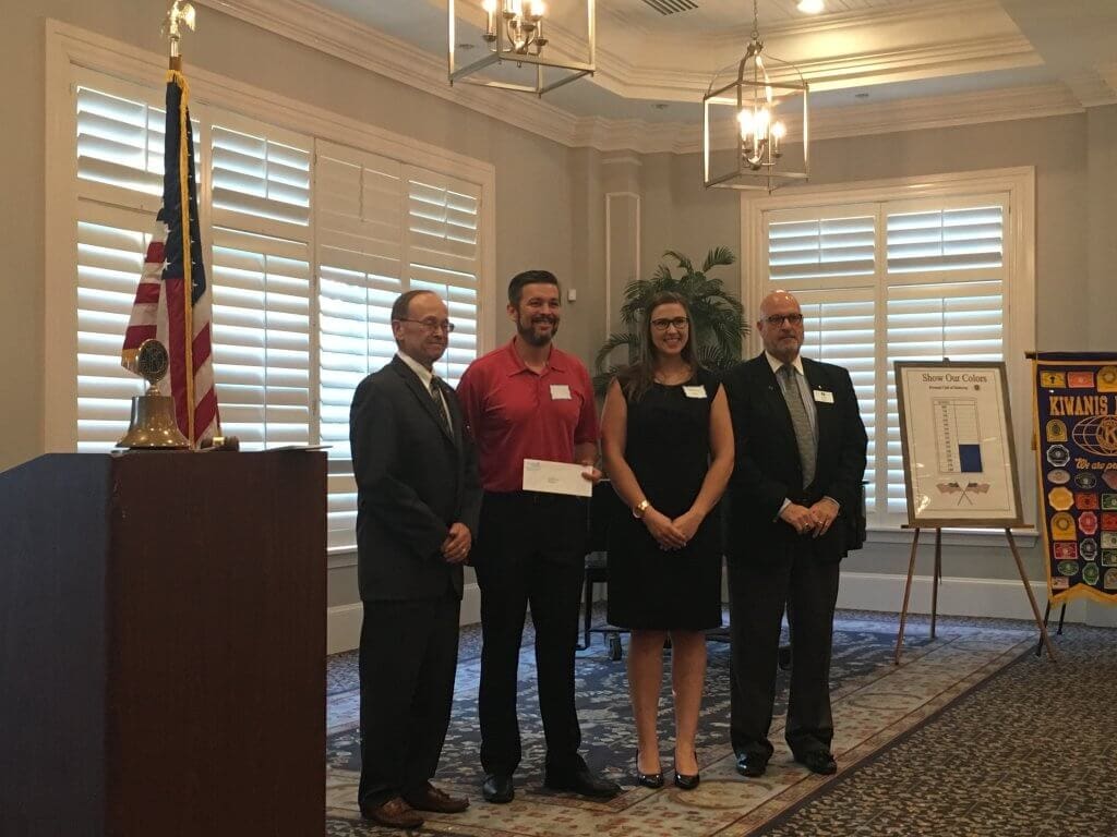 Left to Right Ben Gustafson President of Kiwanis presents a grant to Performance Initiatives board members Will Dent Lindsey Little and Jeff Heeder