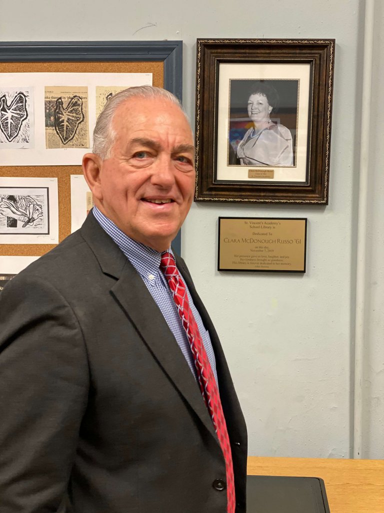 Charles Russo stands in front of the plaque honoring his late wife Clara at the St. Vincent’s Academy library dedication ceremony